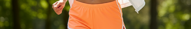 Woman wearing orange sports shorts